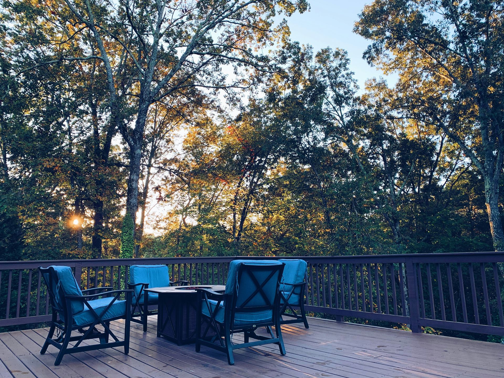 black metal chairs and table near green trees during daytime